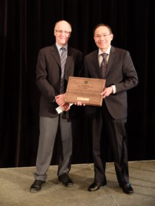 John Howie, Associate Professor with UBC, presents Alex with the VGS Award